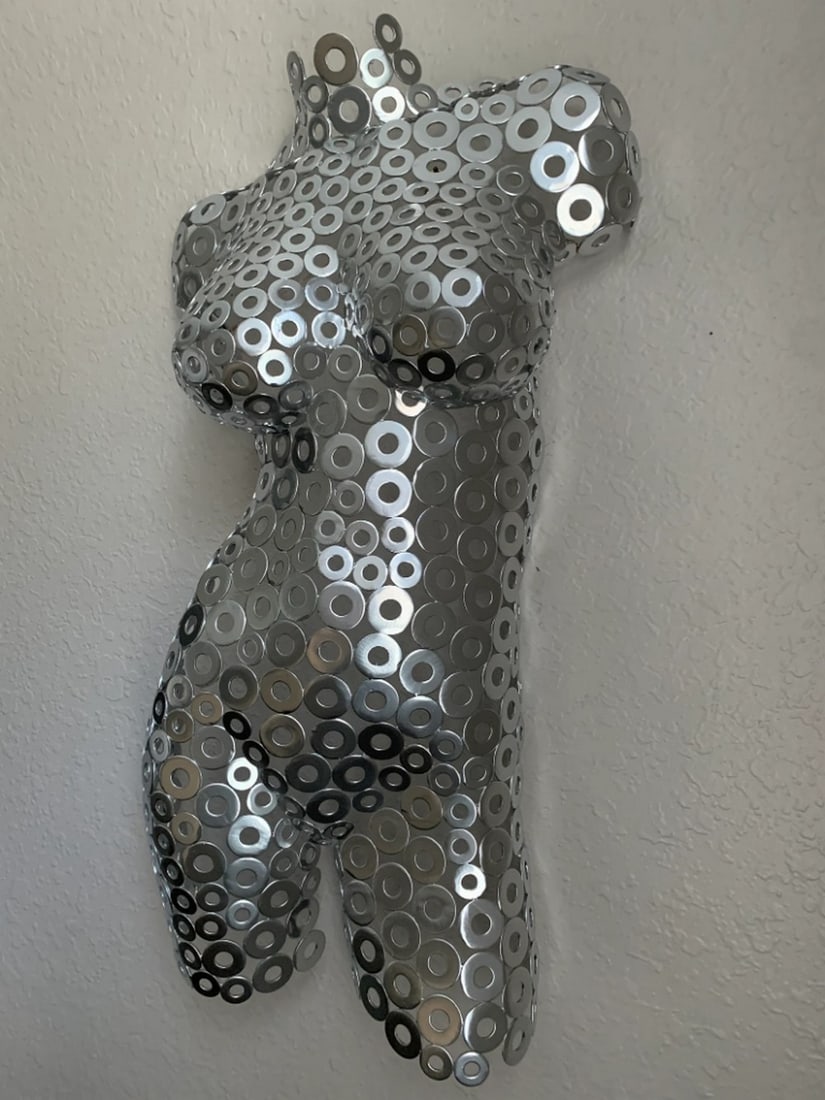 Chrome Metal Female Torso Sculpture: Chrome Metal Female Torso Sculpture This magnificent female torso was hand-formed and welded, making each piece unique and a perfect addition to any art collection. The artwork goes beyond the medium