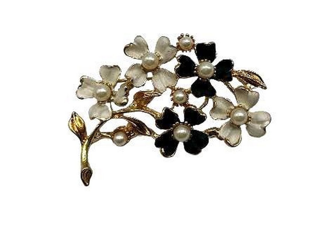 Black and White Floral Brooch with Inlaid White Pearl Accents with: Black and White Floral Brooch with Inlaid White Pearl Accents with White pearls are thought to symbolize innocence, new beginnings, beauty and sincerity. They have also been said to signify femininity