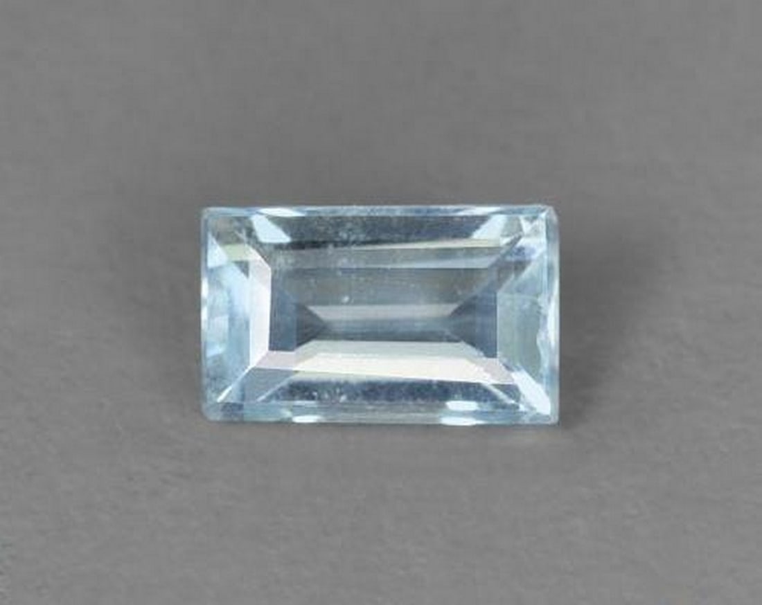 0.26 ct Baguette Natural Light Sky Blue Aquamarine: 0.26 ct Baguette Natural Light Sky Blue Aquamarine This natural 0.26-carat aquamarine from India is cut in a sleek baguette faceted shape, showcasing a delicate light sky blue hue. With VS clarity and