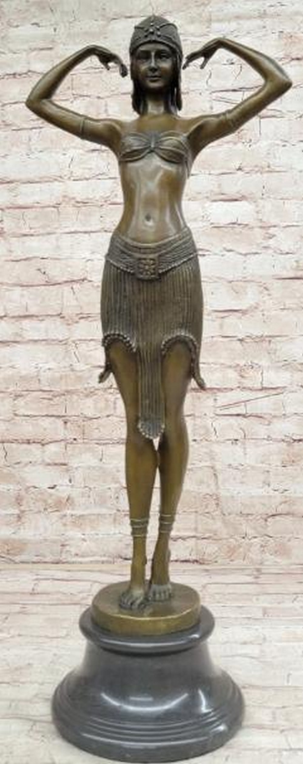 Elegance in Ascent Bronze Sculpture: Elegance in Ascent Bronze Sculpture This exquisite Art Nouveau reproduction bronze sculpture captures a moment of graceful elevation, inspired by the iconic works of Demetre Chiparus. The figure is a 