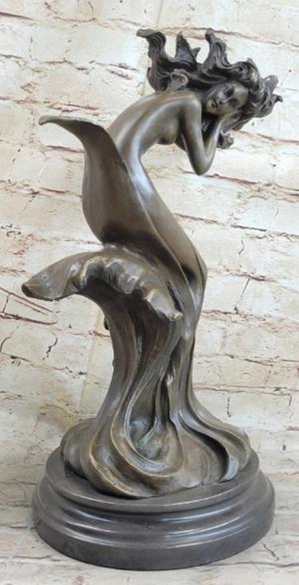 Whispers of the Sea Bronze Sculpture: Whispers of the Sea Bronze Sculpture This enchanting bronze sculpture, bearing the signature of artist Milo, portrays a mystical water goddess, part woman, part mermaid, gracefully seated atop a styli