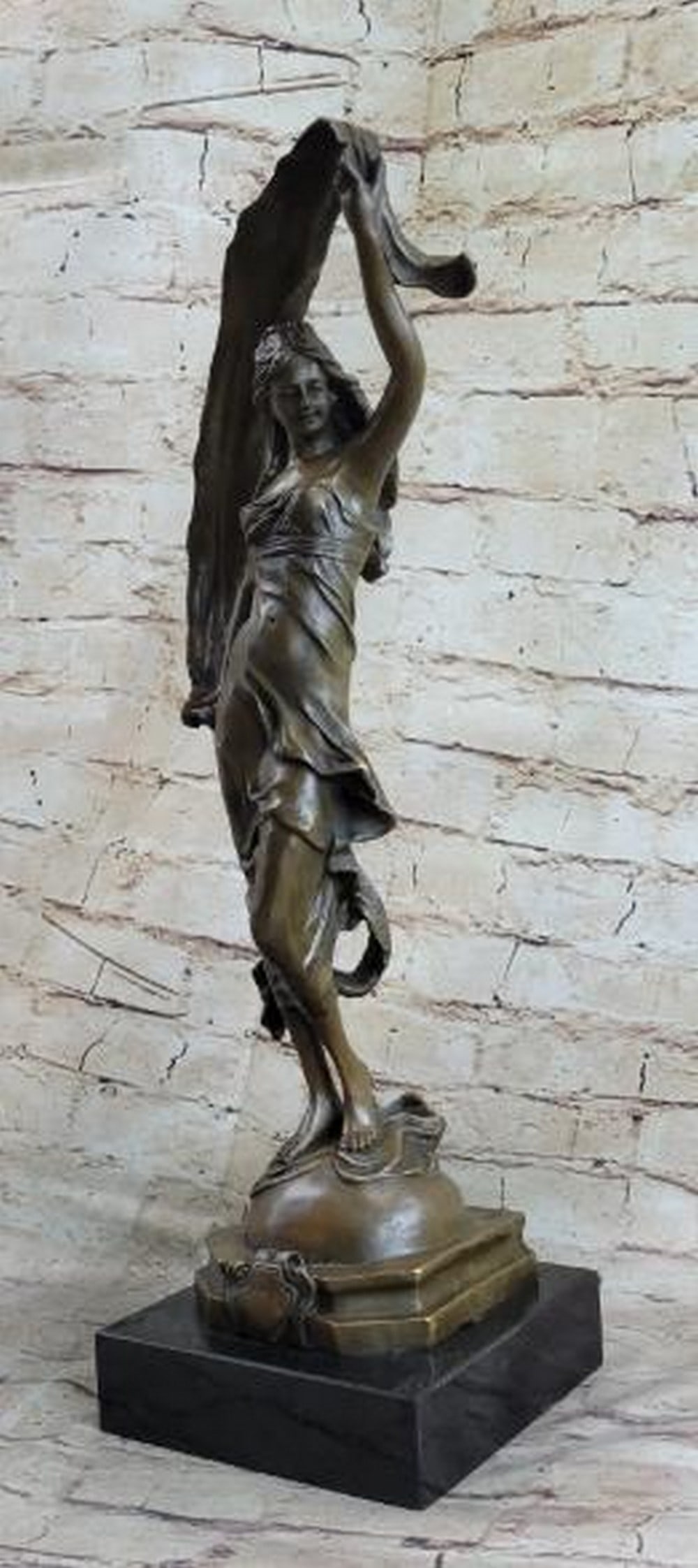 Dance of the Silken Wind Bronze Sculpture: Dance of the Silken Wind Bronze Sculpture This elegant bronze sculpture, bearing the signature of artist Milo, captures the fluid grace of a dancer mid-performance. Balanced atop a marble base, the yo