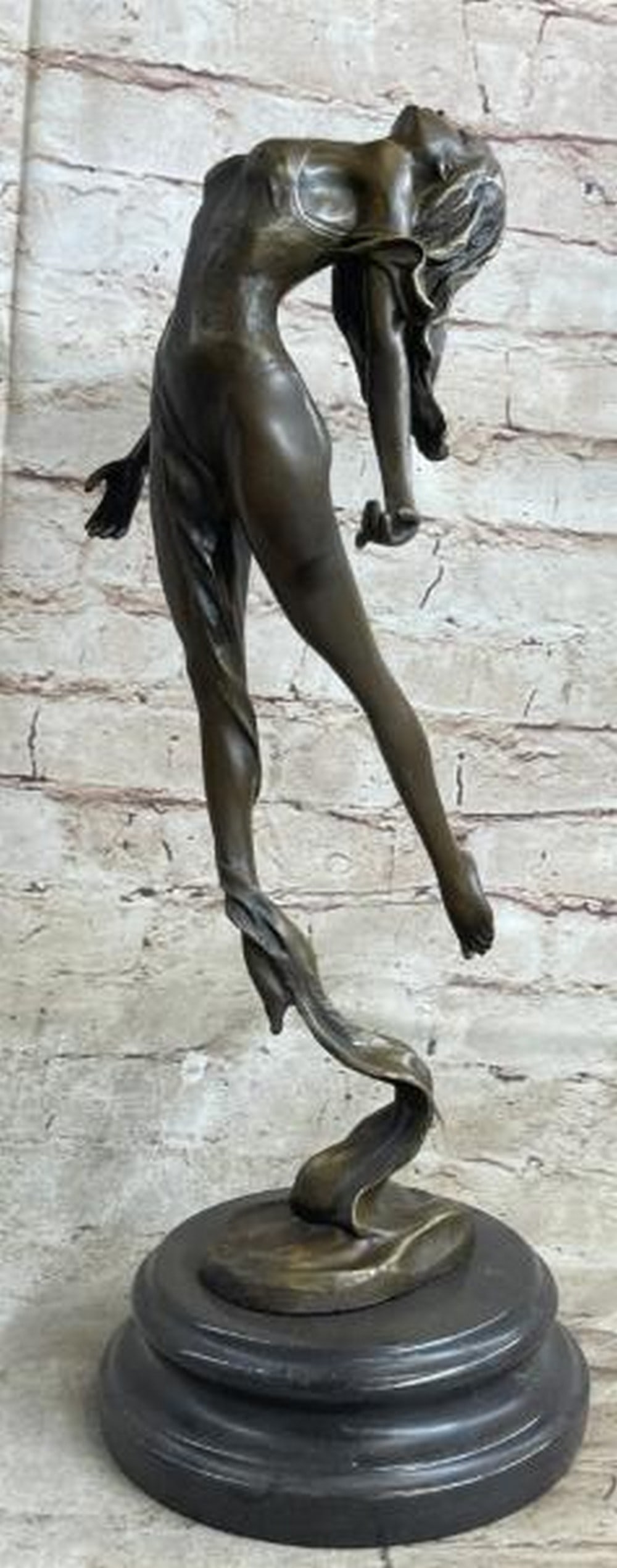 Weightless Grace: Bronze Sculpture of Floating Dancer: Weightless Grace: Bronze Sculpture of Floating Dancer Ethereal and full of motion, this captivating bronze sculpture depicts a dancer caught in a moment of suspended elegance. With her back arched and