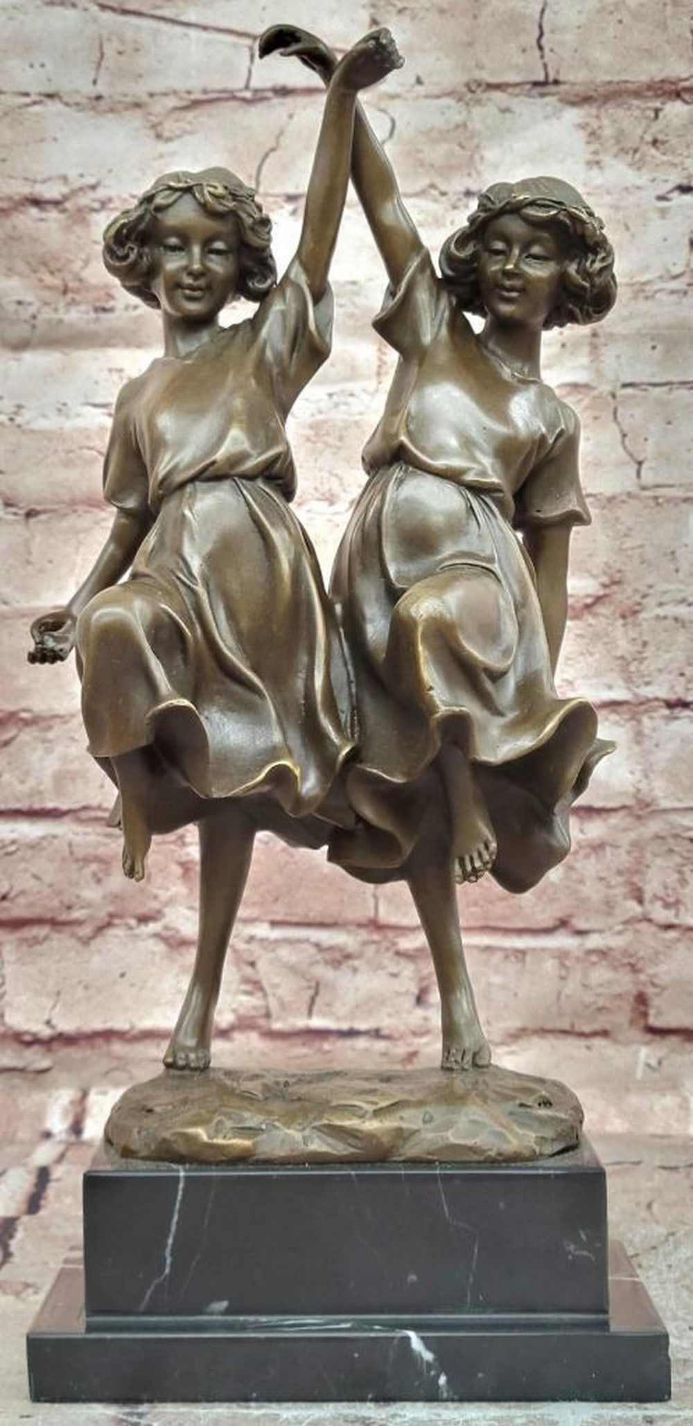 Twin Dancing Girls Bronze Statue - 13.5" x 6": Twin Dancing Girls Bronze Statue - 13.5" x 6" This bronze statue depicts two young dancers posed in synchronized movement, with flowing lines and balanced composition that emphasize grace, rhy
