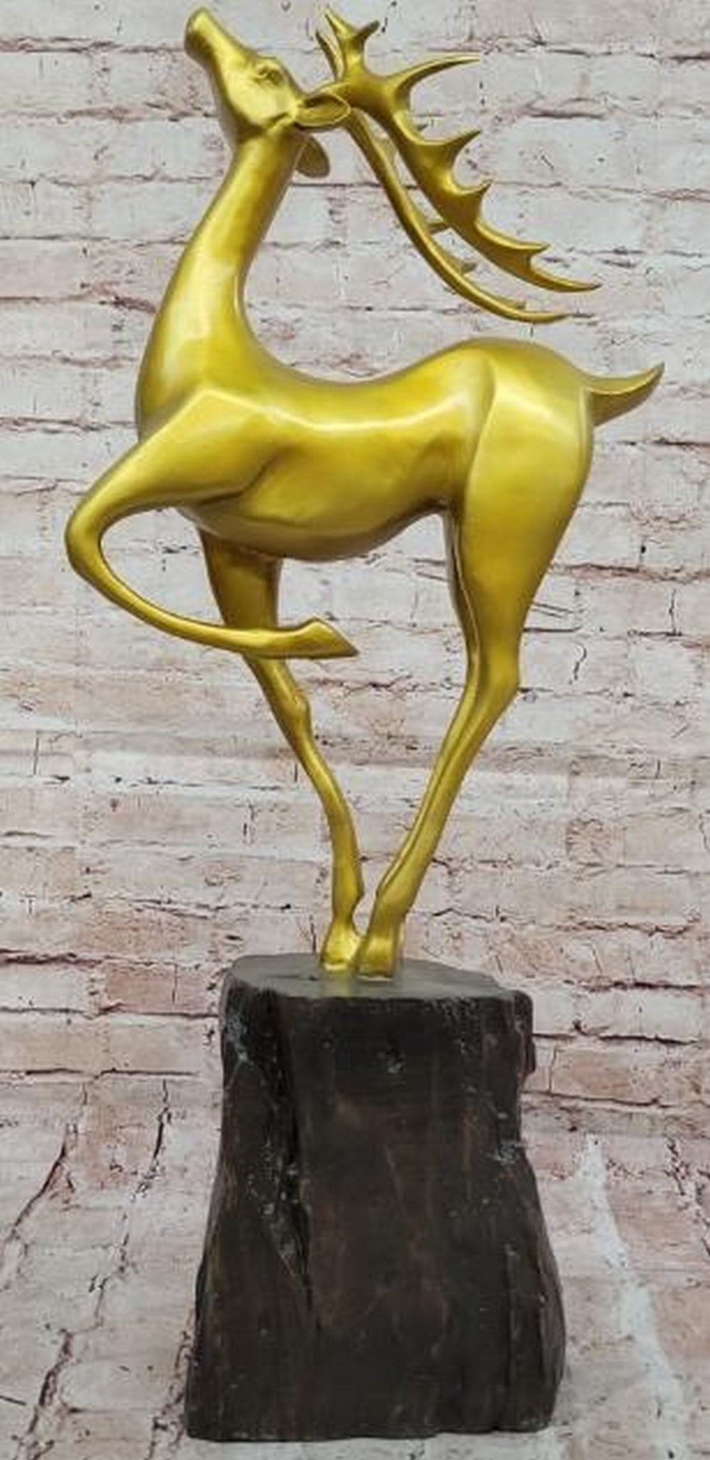 Majestic Vigil: Bronze Stag in Gold Patina: Majestic Vigil: Bronze Stag in Gold Patina Radiating strength and grace, this bronze sculpture with a luminous gold patina captures a deer frozen in a moment of noble stillness. With its head held hig