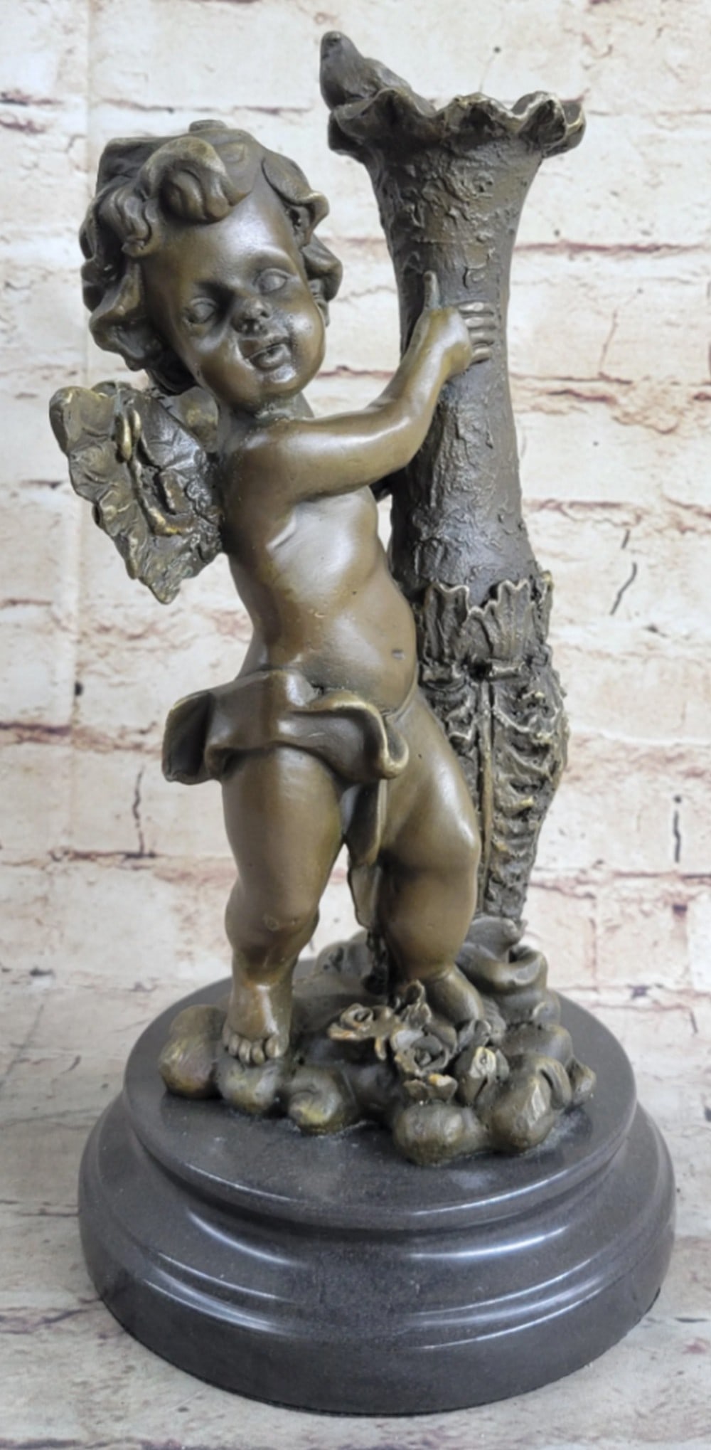 Cherub Angel Bronze Statue: Cherub Angel Bronze Statue The cherubic angel seems to have just landed from great heights among the ruins of an old enchanted garden. He holds himself steady from the fall to earth against a forgotte