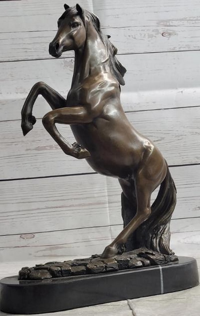 Rearing Horse Bronze Statue: Rearing Horse Bronze Statue Full of energy and motion, this bronze metal statue depicts a rearing horse in a moment of wild strength and spirited defiance. With finely detailed musculature and flowing