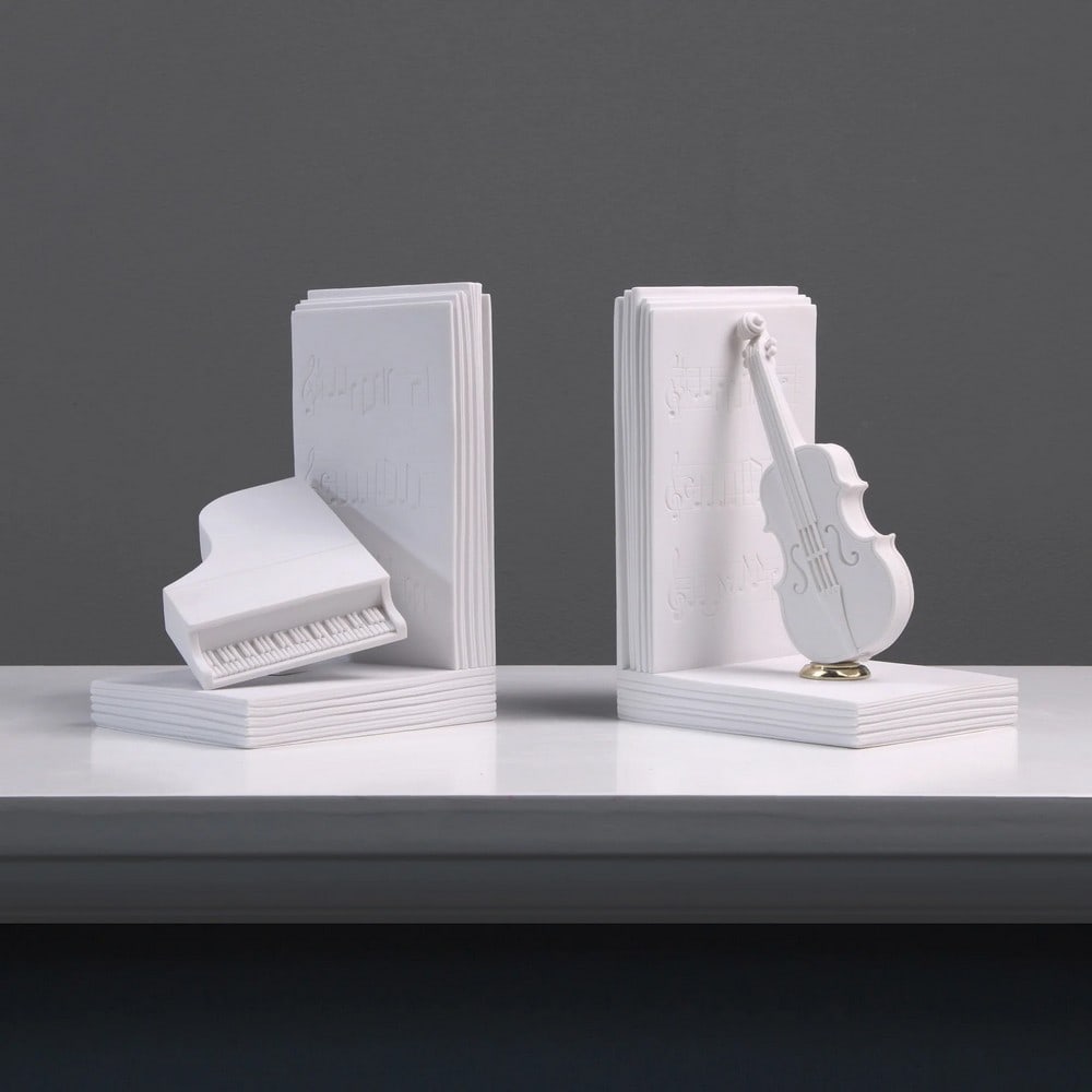 Piano and Violin Bookend in Pair: Piano and Violin Bookend in Pair This elegant pair of bookends beautifully captures the harmony between music and art, featuring sculptural representations of a piano and violin. Designed with refined