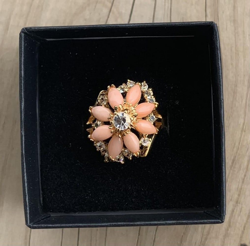Coral Blossom Ring: Coral Blossom Ring Coral is often associated with being a symbol of wisdom, happiness, and immortality. The unique colour of coral is a mixture of pink and orange, pink being a symbol of femininity