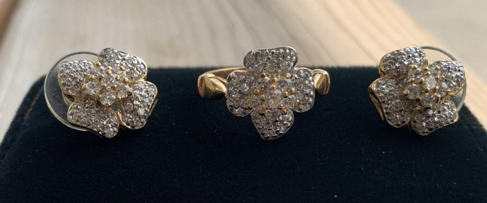 Golden Petal CZ Sparkle Set: Golden Petal CZ Sparkle Set Embrace elegance with this enchanting ring and earrings set, featuring dazzling cubic zirconia stones arranged in a graceful floral motif. The ring showcases a gleaming