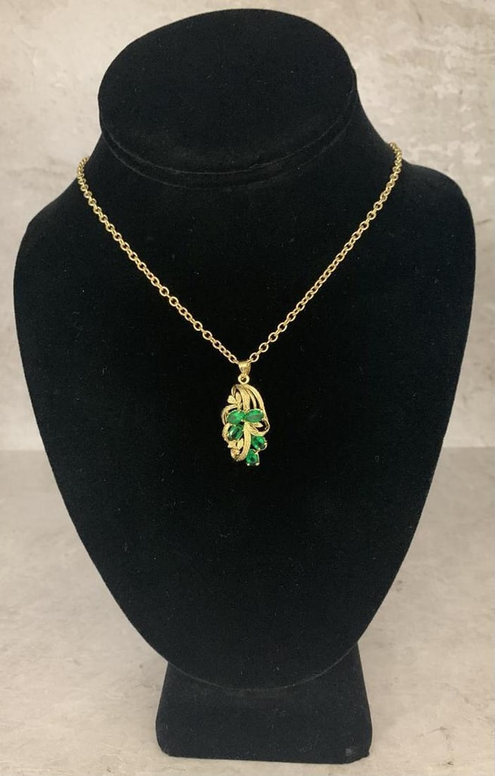 Golden Vine Necklace with Emerald Cluster Pendant: Golden Vine Necklace with Emerald Cluster Pendant This stunning gold necklace features a delicately crafted pendant that evokes nature's elegance. Twisting gold leaves and intricate vine motifs