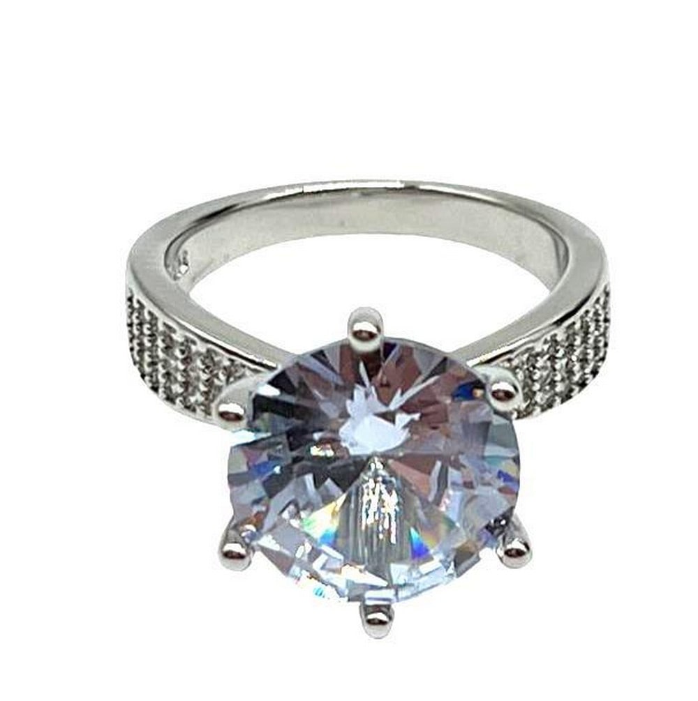 925 Sterling Silver Ring with Round Cut Austrian Crystal: 925 Sterling Silver Ring with Round Cut Austrian Crystal This gorgeous ring features a large round cut Austrian crystal and has additional crystals lining the band. Ring size 7 View photos for