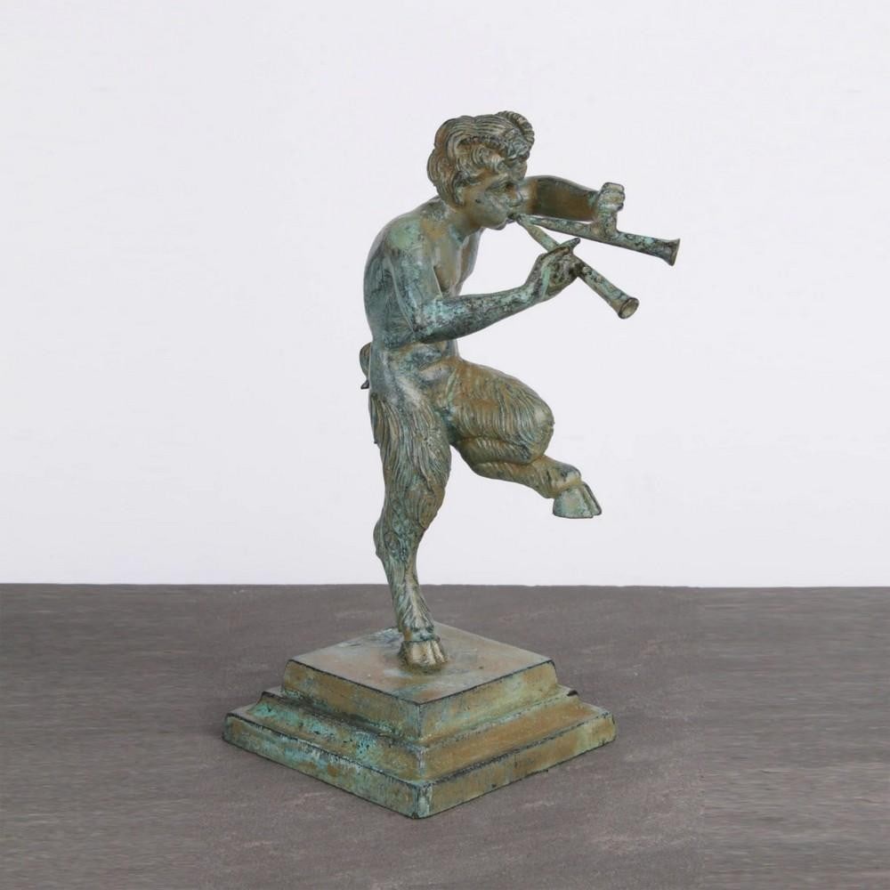 Bronze Satyr Statue of Pan Dancing with Flutes - (1.8lbs): Bronze Satyr Statue of Pan Dancing with Flutes - (1.8lbs) This detailed bronze statuette depicts Pan, the half-man, half-goat god, dancing while playing a pair of flutes. Showcasing Pan's signature