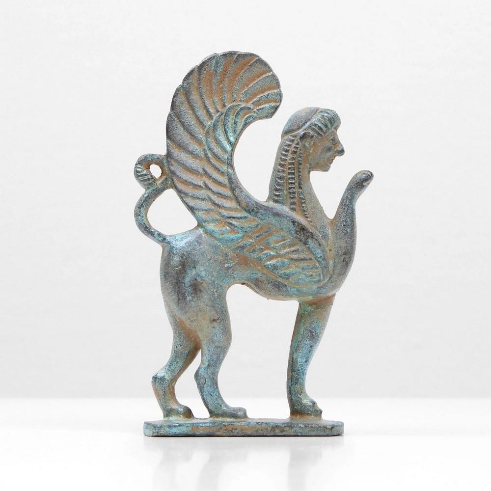 Bronze Green Sphinx Statue - 4.1" x 2.5": Bronze Green Sphinx Statue - 4.1" x 2.5" A sphinx is a mythical creature with the head of a human and the body of a lion, often with the wings of a falcon. In Greek tradition, it is depicted w