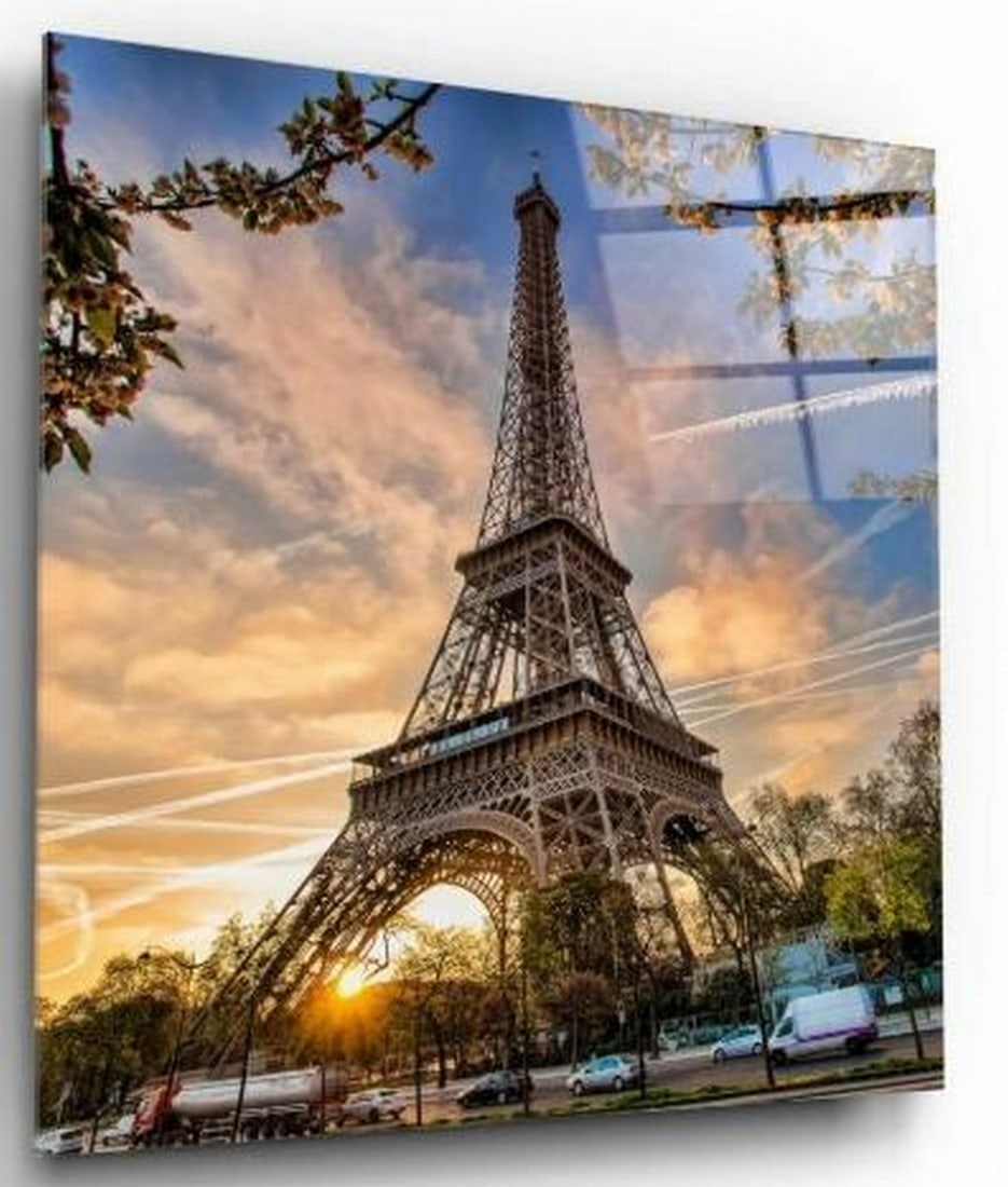 Paris at Dusk Tempered Glass Wall Art: Paris at Dusk Tempered Glass Wall Art This tempered glass wall art captures a unique and enchanting view of the Eiffel Tower from beneath, framed by the soft glow of a setting sun. Taken from a low an