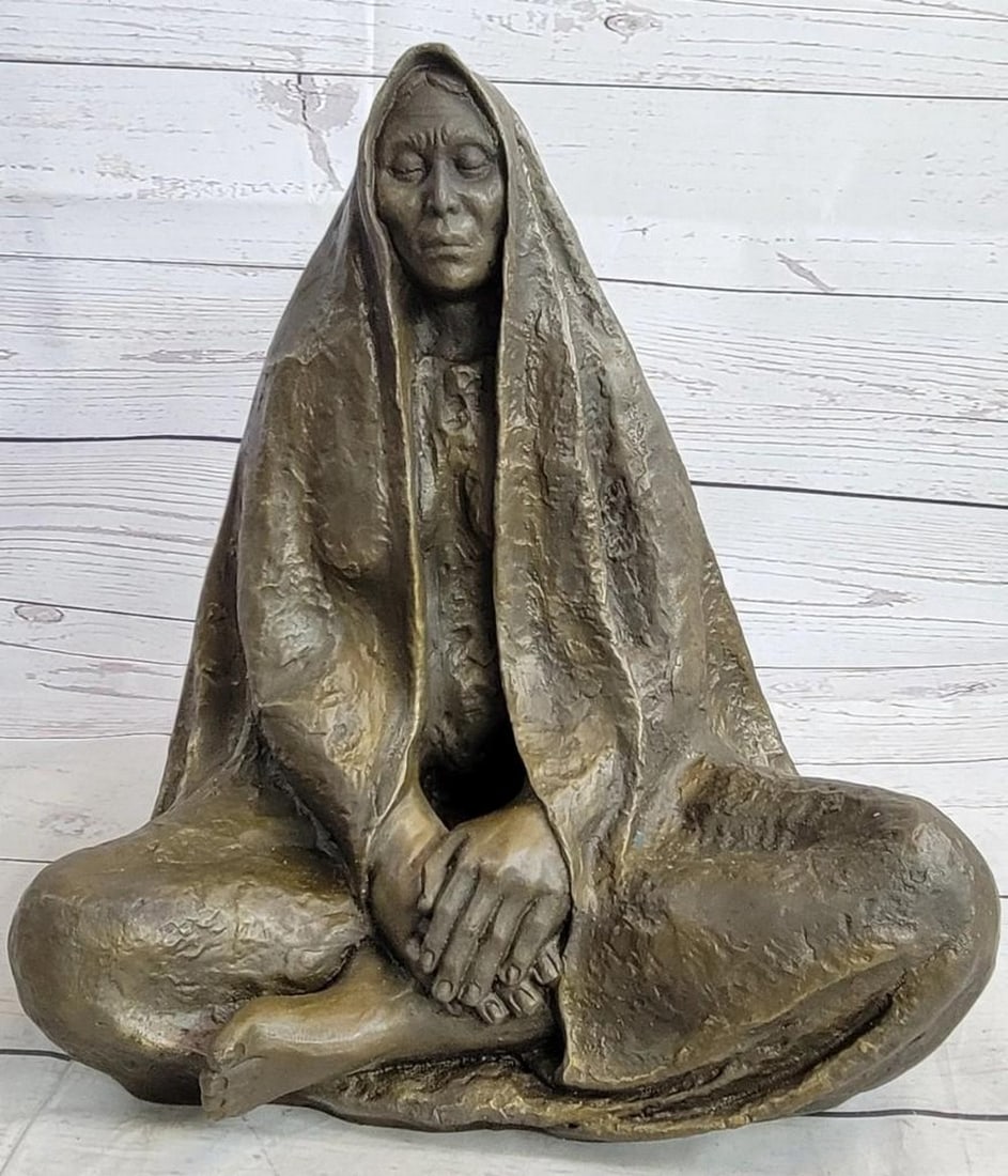 Cloaked Meditating Woman Bronze Sculpture: Cloaked Meditating Woman Bronze Sculpture The Native American shaman sits with the traditional Indian leg-cross on the ground of the earth. The long cloak covers him like a mysterious veil revealing h