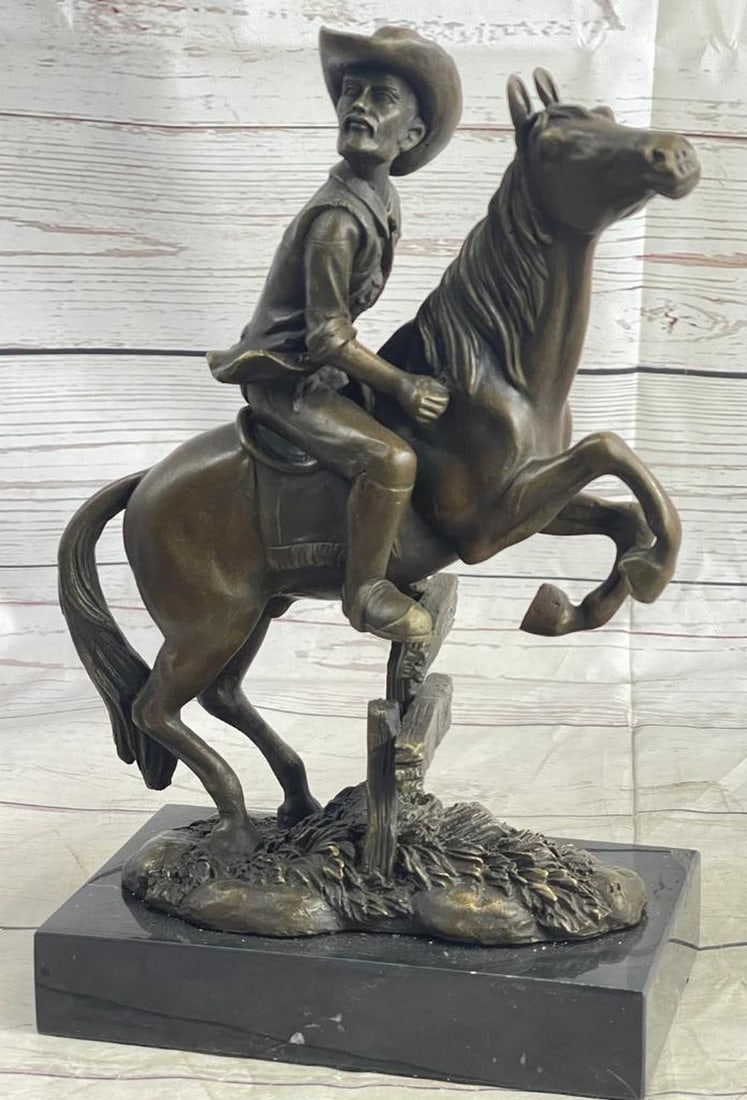 Cowboy Jumping Fence on the Plains Inspired Bronze Statue - 11" x 10": Cowboy Jumping Fence on the Plains Inspired Bronze Statue - 11" x 10" The piece depicts a cowboy in full gallop, expertly guiding his horse over a fence on the open plains. The fine details of