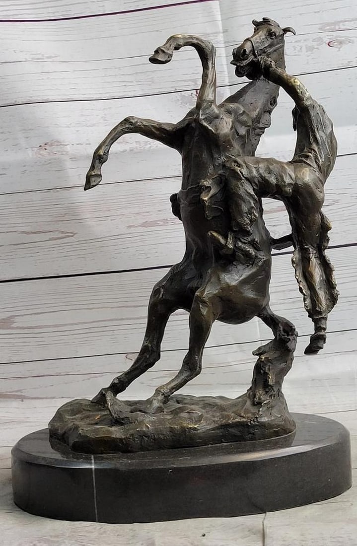 Cowboy Bucked off Horse Inspired Bronze Statue - 15" x 10": Cowboy Bucked off Horse Inspired Bronze Statue - 15" x 10" This bronze statue vividly captures the thrilling moment of a cowboy being bucked off a horse. The horse is dramatically reared up on