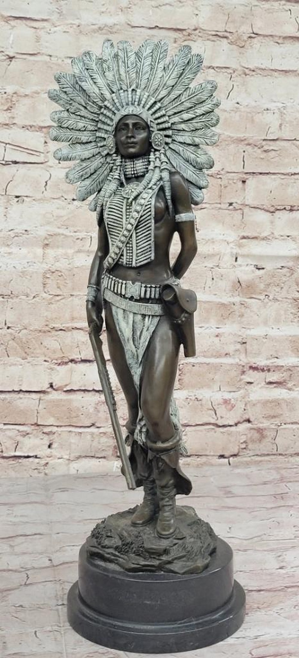 Warrior Girl in Green Patina Feathered Headdress Bronze Statue - 18" x 6": Warrior Girl in Green Patina Feathered Headdress Bronze Statue - 18" x 6" A fierce Native American women prepares to hunt. She stands tall with bravery, silent confidence and stunning beauty o
