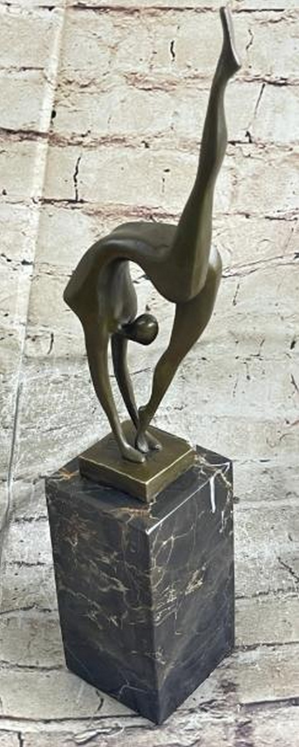 Abstract Bronze Ballerina in Motion: Abstract Bronze Ballerina in Motion This sculpture captures a moment of breathtaking flexibility and poise in this abstract bronze ballerina sculpture. Balancing delicately on one foot, the dancer ben