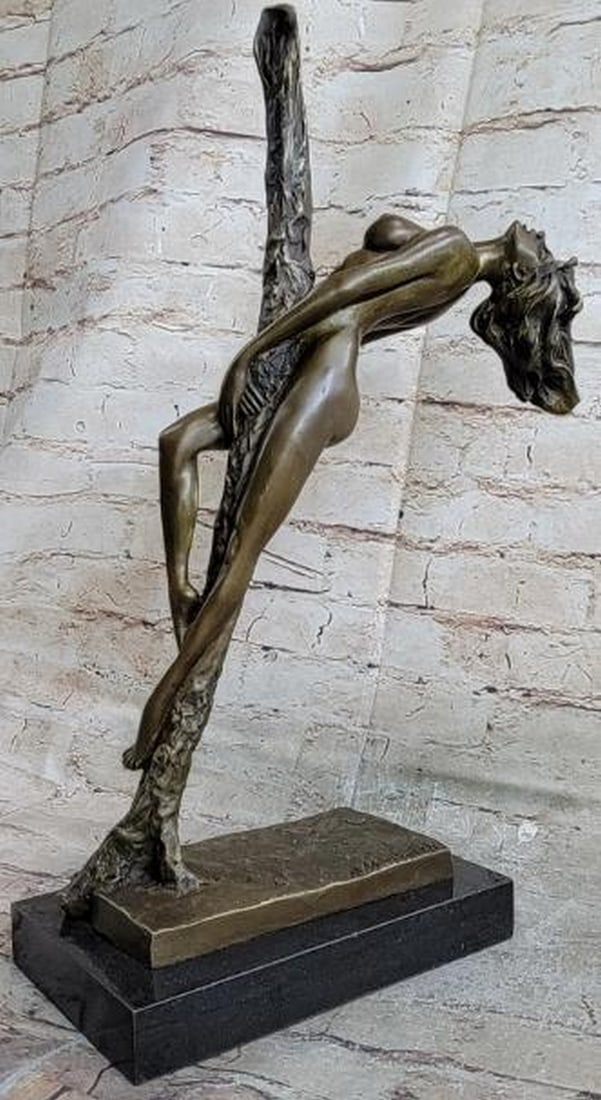 Elegance in Balance Nude Female Bronze Sculpture: Elegance in Balance Nude Female Bronze Sculpture Sensual and striking, this is a finely crafted bronze sculpture of a nude female figure, gracefully leaning back against a vertical pole in a pose that