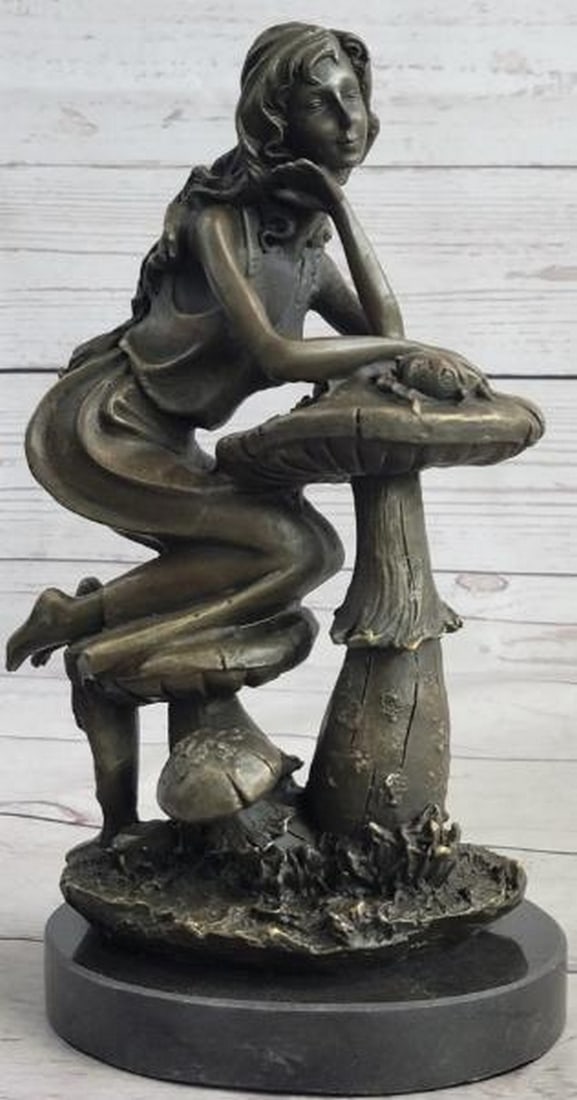 Forest Dreamer Bronze Sculpture: Forest Dreamer Bronze Sculpture Whimsical and serene, this is a captivating bronze sculpture of a young woman kneeling atop oversized mushrooms, her pose filled with quiet introspection. Her hand rest