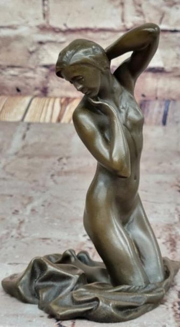 Grace in Repose Nude Bronze Female Figure: Grace in Repose Nude Bronze Female Figure A sensuous expression of elegance and quiet introspection, this exquisite bronze sculpture features a nude female figure posed gracefully on her knees. One ha