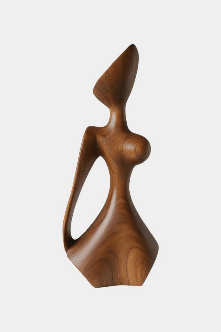 Stylized Female Abstract Wooden Sculpture: Stylized Female Abstract Wooden Sculpture A striking modern sculpture that reimagines the human form through bold abstraction and flowing geometry. With an elongated triangular head, curvaceous torso,