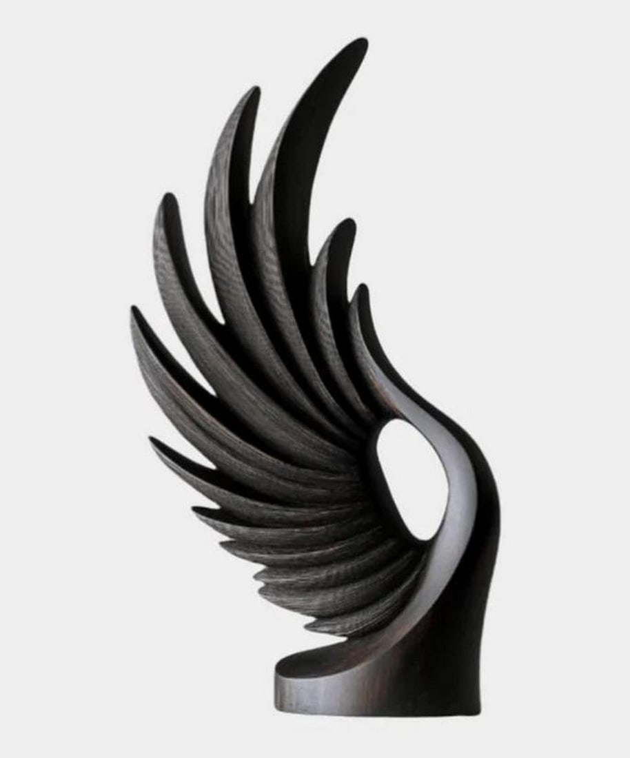 Obsidian Wing - Contemporary Flight Wooden Sculpture: Obsidian Wing - Contemporary Flight Wooden Sculpture A captivating black wood sculpture, masterfully crafted to evoke the form and fluidity of a bird's wing in mid-flight. With its graceful arcs and l