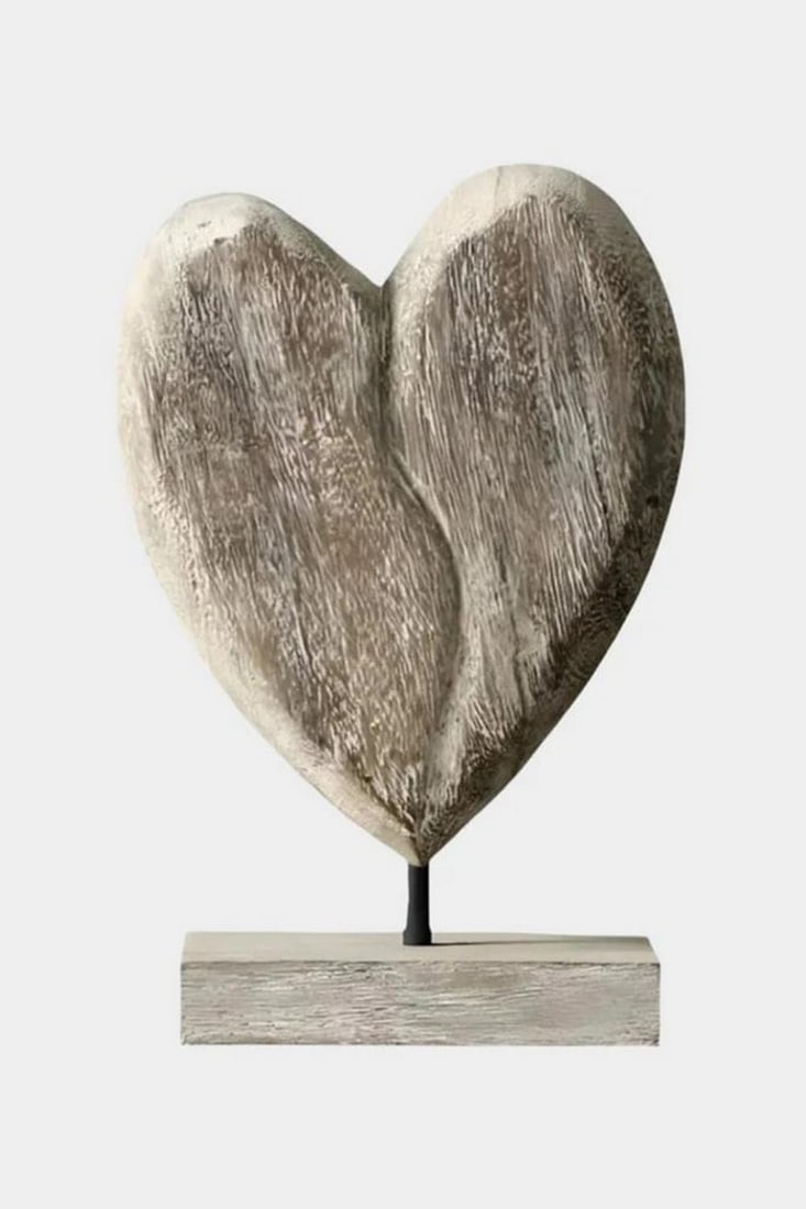 "Worn Heart of the Wild" Wooden Sculpture: "Worn Heart of the Wild" Wooden Sculpture A beautifully imperfect heart carved from wood, this sculpture evokes the raw warmth of nature and the resilience of love. Its asymmetry and