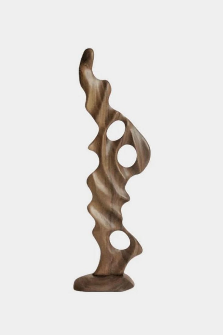 Echoes of the Forest Hand-Carved Sculpture: Echoes of the Forest Hand-Carved Sculpture Shaped by hand from richly grained hardwood, this sculpture evokes the natural rhythms of forest growth - fluid, wild, and harmonious. Its twin hollow