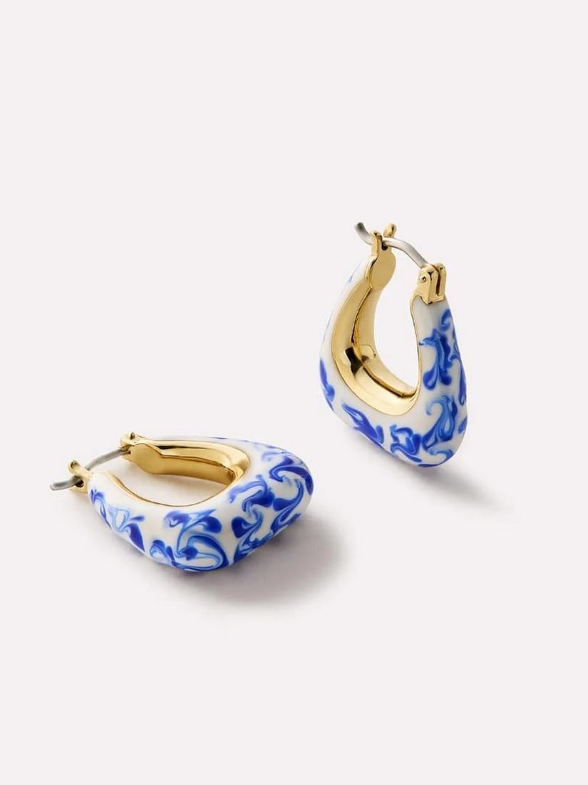Marble Blue 14k Gold-Plated Trapezoid Hoop Earrings: Marble Blue 14k Gold-Plated Trapezoid Hoop Earrings These earrings feature a trapezoid-shaped hoop design plated in 14k gold with hand-painted blue marble enamel detailing, and the thicker silhouette
