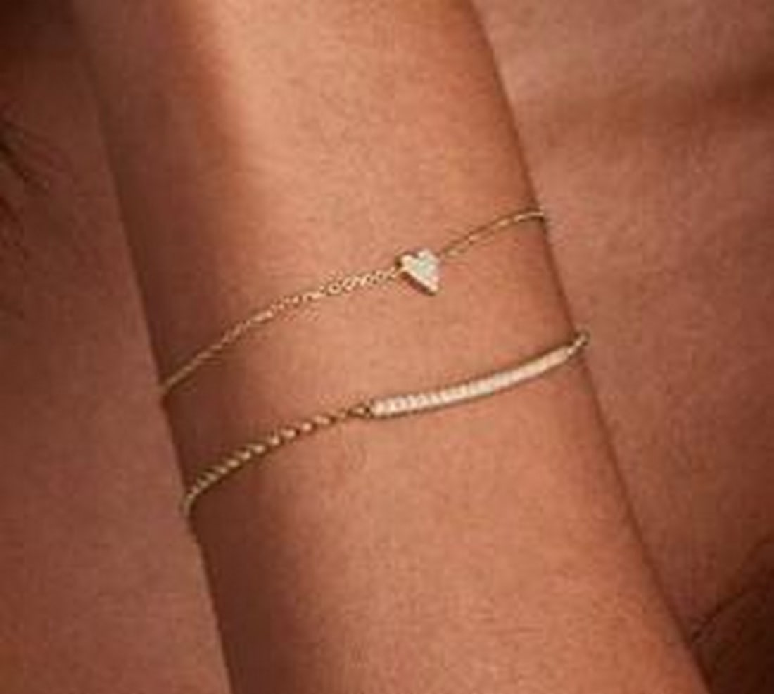 Whisper Heart Diamond Bracelet: Whisper Heart Diamond Bracelet A delicate symbol of love, this bracelet features a petite heart charm encrusted with shimmering pave-set diamonds. Suspended on a fine chain, the minimalist silhouette 