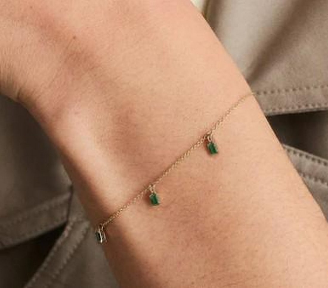 Floating Triple Baguette Gemstone Bracelet: Floating Triple Baguette Gemstone Bracelet Three baguette-cut gemstones are delicately spaced along a fine chain, giving the illusion of floating brilliance across the wrist. Each stone sways gently w