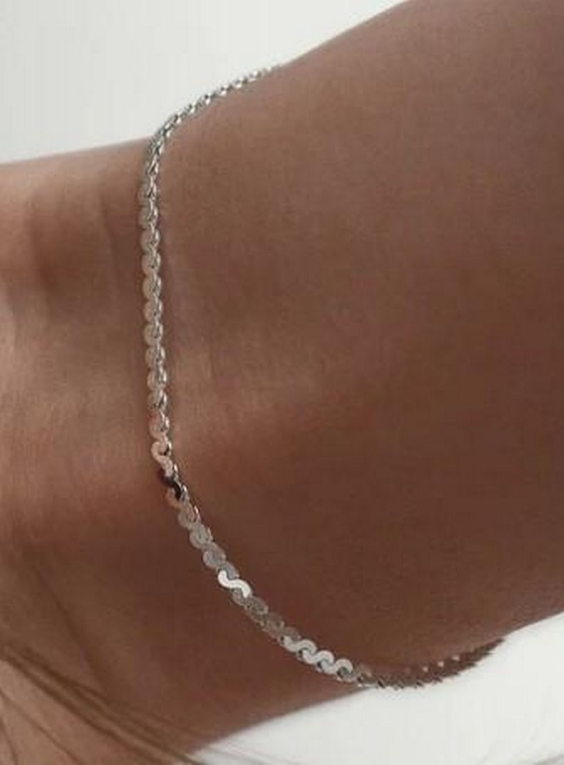 Sleek Serpentine Bracelet: Sleek Serpentine Bracelet Smooth and fluid, this serpentine chain bracelet glides around the wrist with a subtle shimmer. Crafted with tightly linked, wave-like curves, it reflects light beautifully