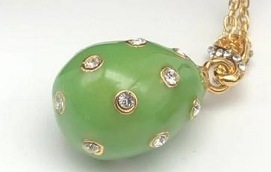 Classic Green Egg Pendant with Gold Necklace: Classic Green Egg Pendant with Gold Necklace This classic green egg pendant features a smooth, medium green enamel finish that glows with understated charm. Paired with a polished gold-tone necklace,