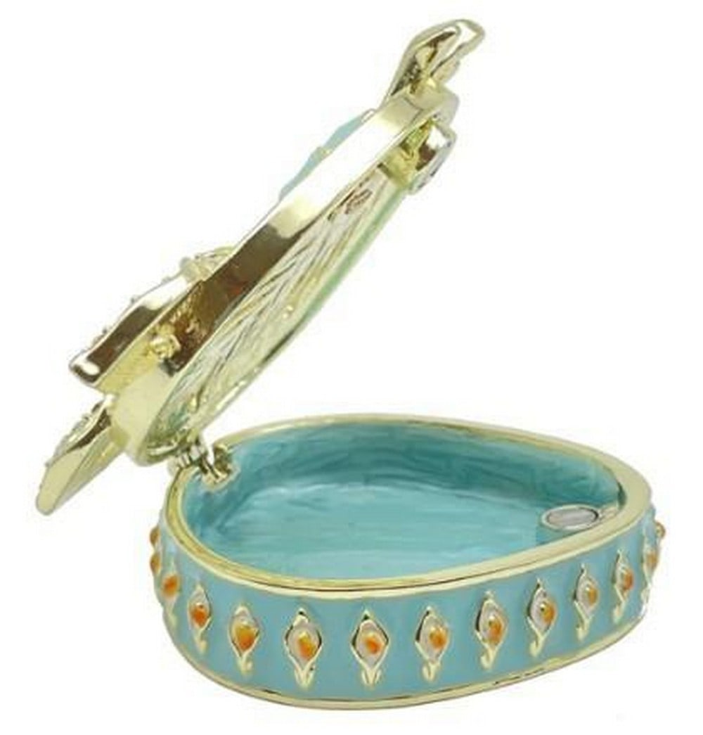Lush Turquoise Treasures Box: Lush Turquoise Treasures Box Elegant and eye-catching, this green turquoise trinket box shimmers with ornate detailing and jewel-like accents. The rich enamel finish is complemented by gold-toned embe