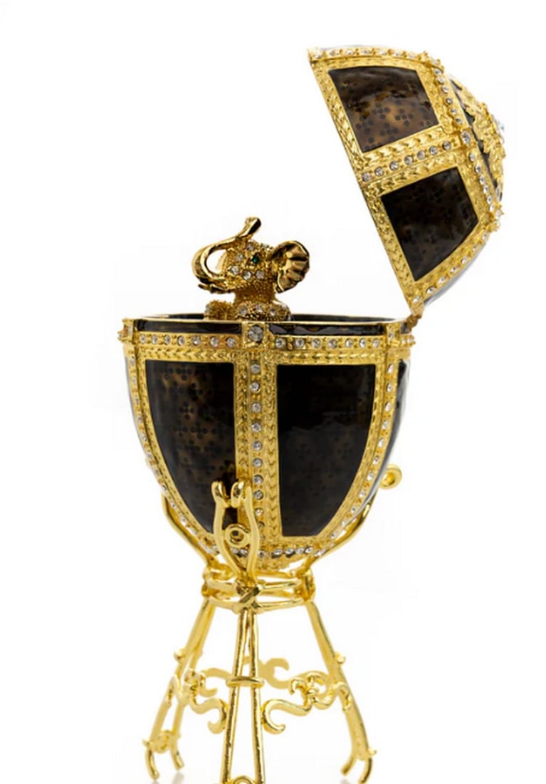 Gold Crystal Elephant on Black & Gold Egg: Gold Crystal Elephant on Black & Gold Egg This enamel-painted trinket box features a lovely handmade black and gold egg adorned with a gold crystal elephant. A unique one-of-a-kind piece designed for