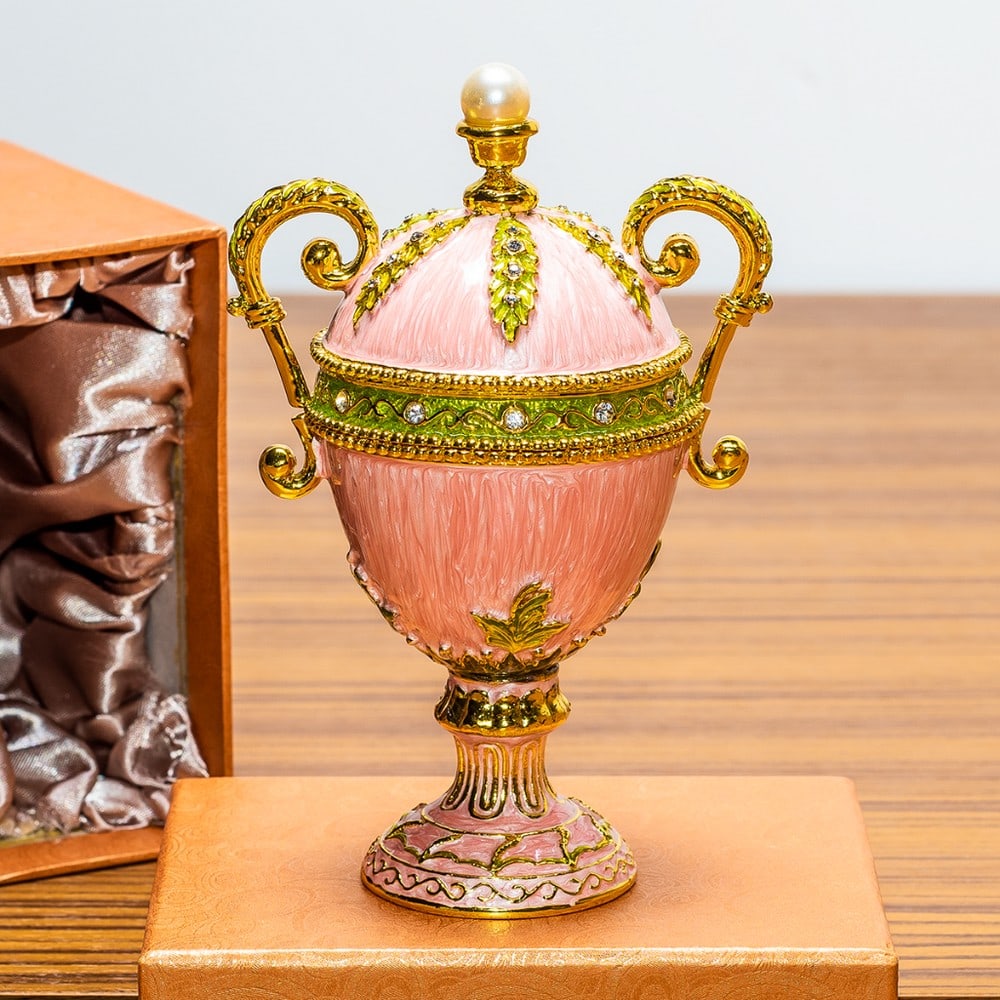 Pink Amphora Enameled Royal Inspired Egg Figurine: Pink Amphora Enameled Royal Inspired Egg Figurine You'll love the elegance of this pink-hued Royal inspired Russian Easter egg. A display stand attached to this beauty. Fashioned from fine pewter.