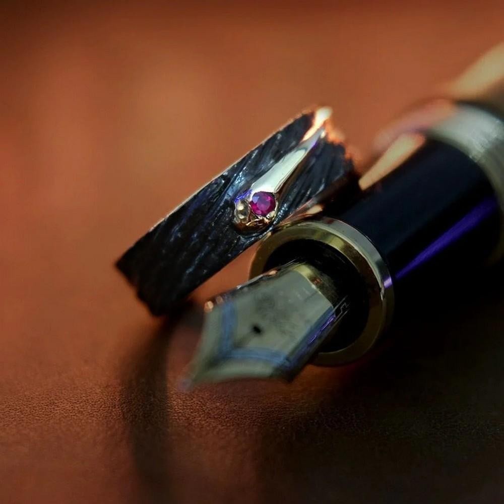 Meteorite and Fire Ring: Meteorite and Fire Ring Handcrafted by Mongolian artisans, the Meteorite and Fire Ring fuses cosmic wonder with traditional skill. A genuine fragment of meteorite is set into a finely polished metal