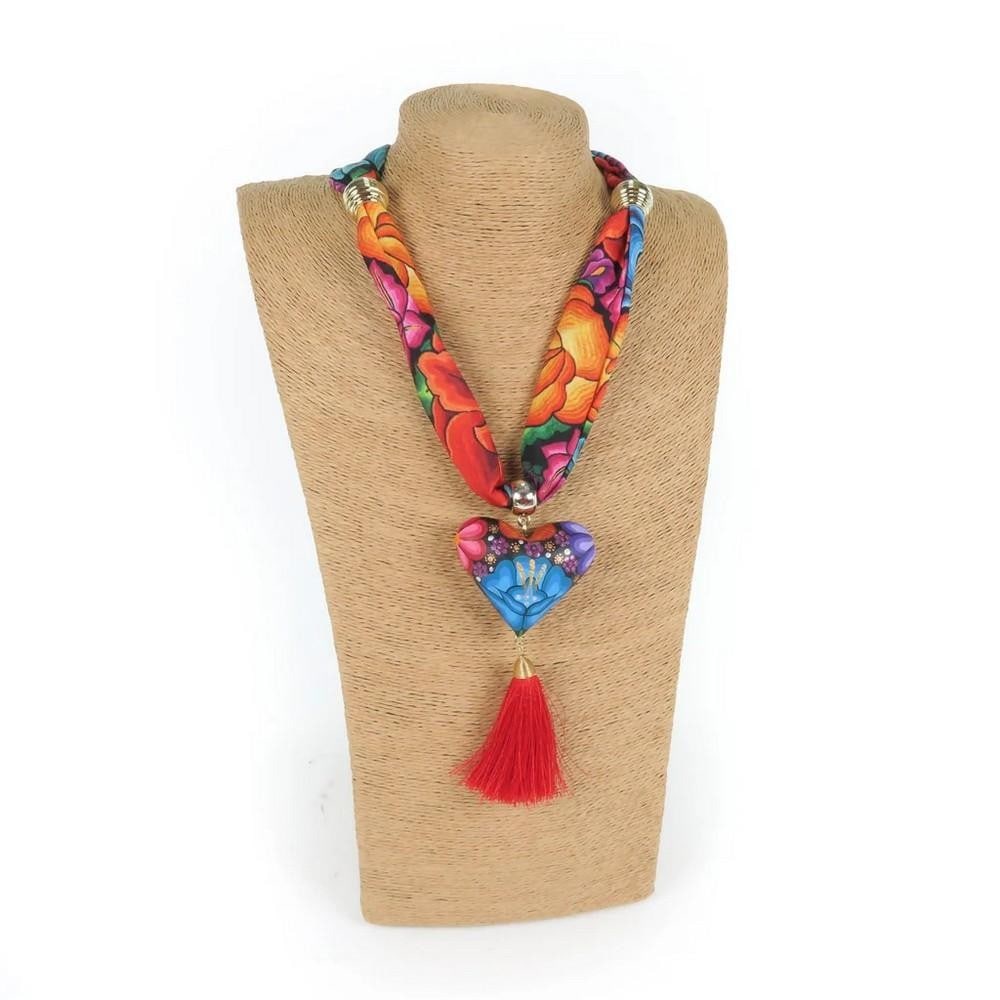 Oaxacan Alebrije Wood Carving Heart & Flowers Necklace: Oaxacan Alebrije Wood Carving Heart & Flowers Necklace Gorgeous heart necklace handcrafted from locally sourced copal wood, painted with colorful floral designs and traditional Zapotec patterns.
