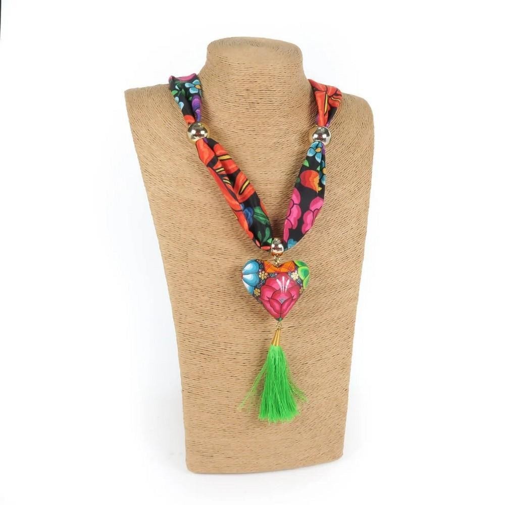 Oaxacan Alebrije Wood Carving Heart & Flowers Necklace: Oaxacan Alebrije Wood Carving Heart & Flowers Necklace Gorgeous heart necklace handcrafted from locally sourced copal wood and decorated with colorful floral designs and traditional Zapotec patterns.