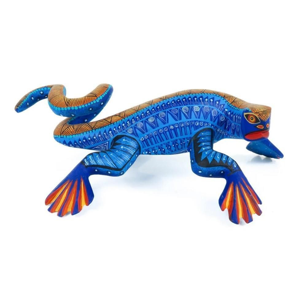 Masterpiece Iguana - Oaxacan Alebrije Wood Carving: Masterpiece Iguana - Oaxacan Alebrije Wood Carving From the heart of Oaxaca comes this breathtaking Zapotec iguana alebrije, hand-carved from a single piece of copal wood by acclaimed artist Nestor Me