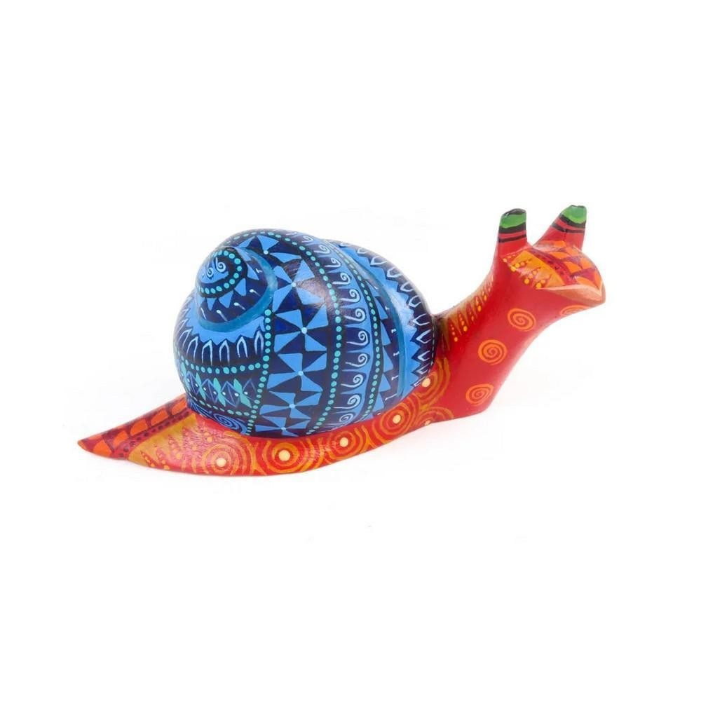 Snail - Oaxacan Alebrije Wood Carving: Snail - Oaxacan Alebrije Wood Carving A wonderfully imaginative creation by the Calvo family workshop, this charming snail alebrije is hand-carved from a single piece of copal wood. Adorned with tradi