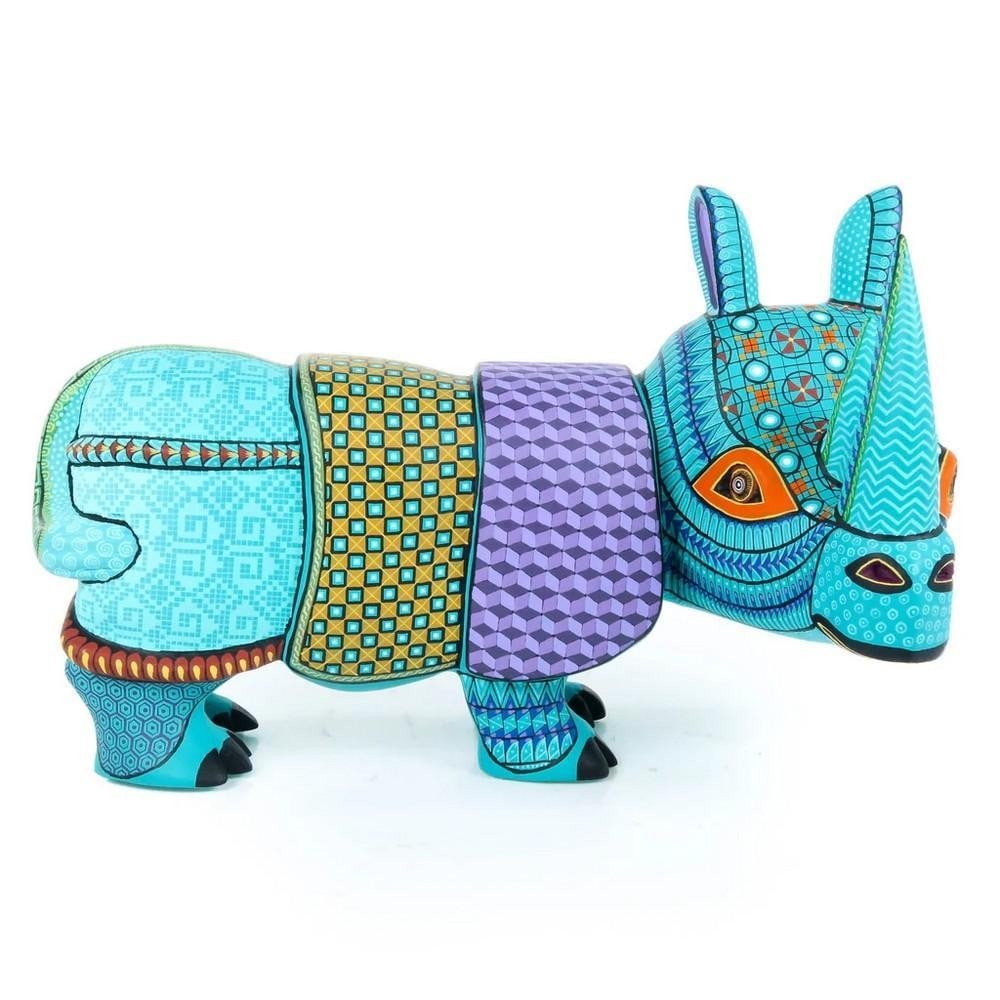 Bold Turquoise Rhino - Premium Oaxacan Alebrije by the Fabian Family: Bold Turquoise Rhino - Premium Oaxacan Alebrije by the Fabian Family This striking Turquoise Rhino alebrije is a premium creation by the Fabian family, master artisans from San Martin Tilcajete, Oaxac