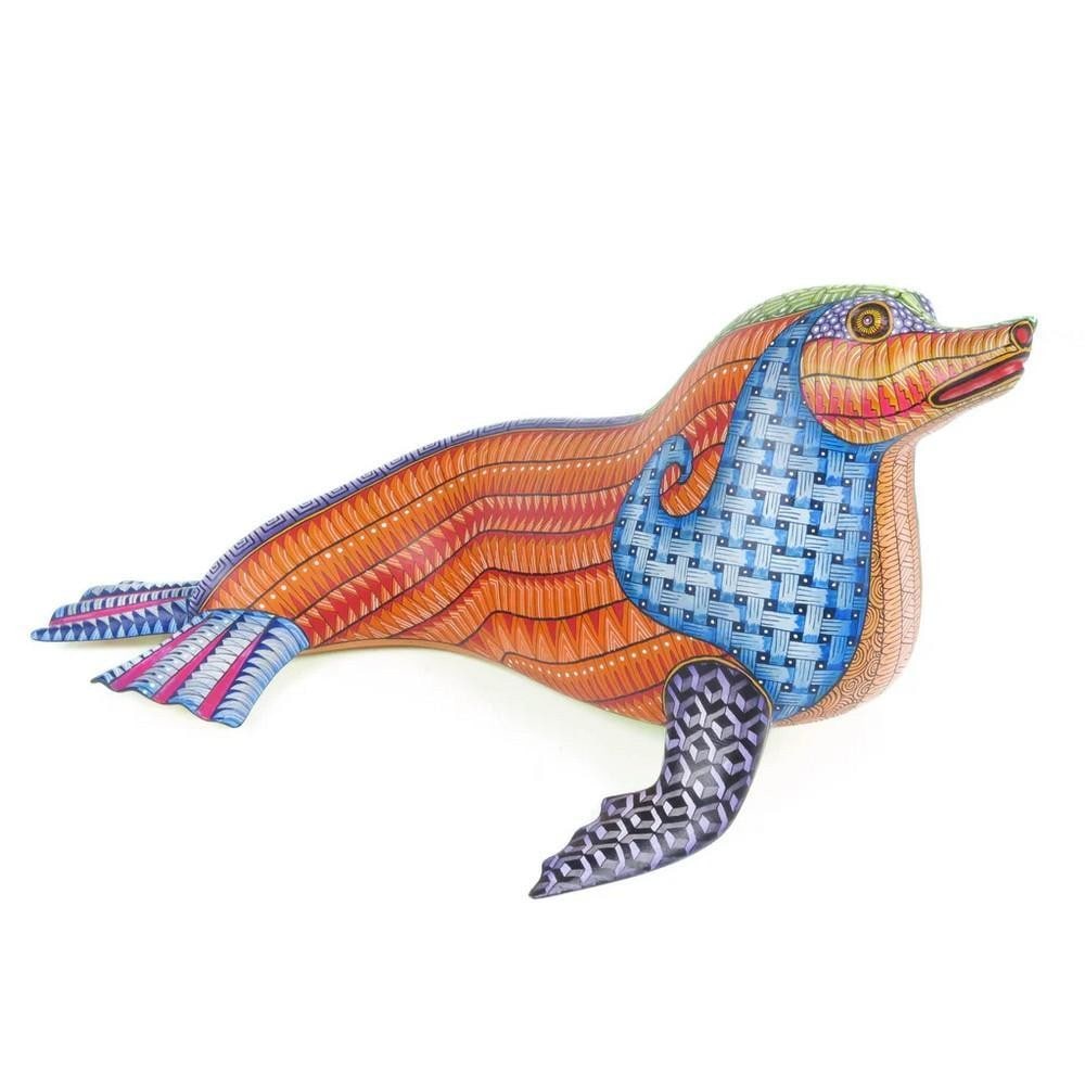 Dual Realm Seal - Oaxacan Alebrije by the Morales Family: Dual Realm Seal - Oaxacan Alebrije by the Morales Family Gliding between land and sea, this extraordinary seal alebrije channels the wisdom of two worlds. Hand-carved in Arrazola, Oaxaca by the acclai