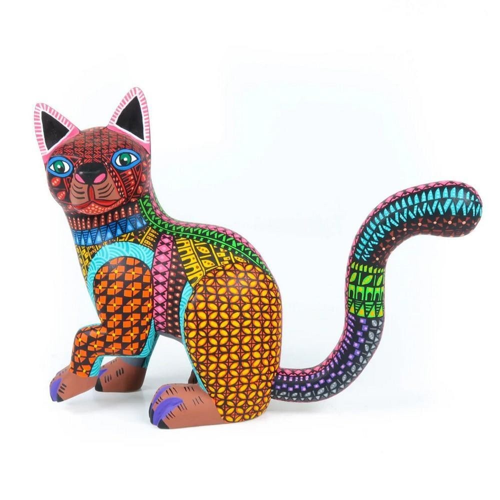 Shy Cat - Vibrant Oaxacan Alebrije Wood Carving: Shy Cat - Vibrant Oaxacan Alebrije Wood Carving The Shy Cat alebrije is a vibrant and captivating piece handcrafted by the renowned Ramirez family workshop in Oaxaca, Mexico. Expertly carved from sust