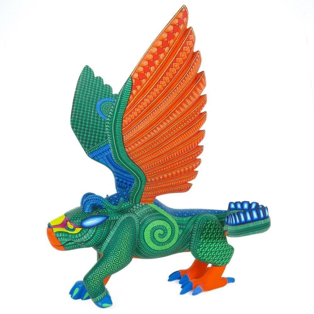 Zapotec Pepita Winged Jaguar - Oaxacan Alebrije Wood Carving: Zapotec Pepita Winged Jaguar - Oaxacan Alebrije Wood Carving Museum-quality alebrije hand-carved by the Fabian Family of Oaxaca, inspired by Pepita from Coco. This striking piece blends jaguar feature