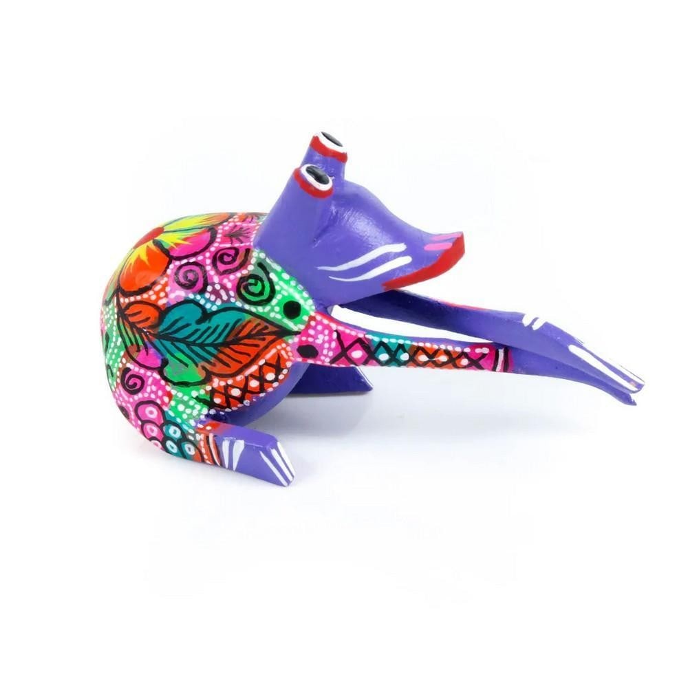 Mini Frog - Handcrafted Oaxacan Alebrije: Mini Frog - Handcrafted Oaxacan Alebrije This adorable Mini Frog alebrije captures the vibrant and enchanting spirit of Oaxacan folk art. Each miniature piece is carefully carved and painted by hand, 