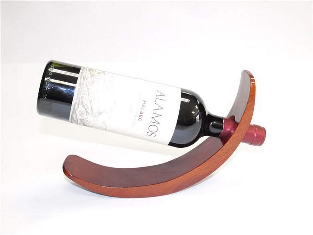 Handcrafted Curved Wood Wine Bottle Holder: Handcrafted Curved Wood Wine Bottle Holder Indulge in sophistication with our remarkable Curved Wood Wine Bottle Holder. Hand-carved to perfection, this piece exudes class and elegance. The high gloss